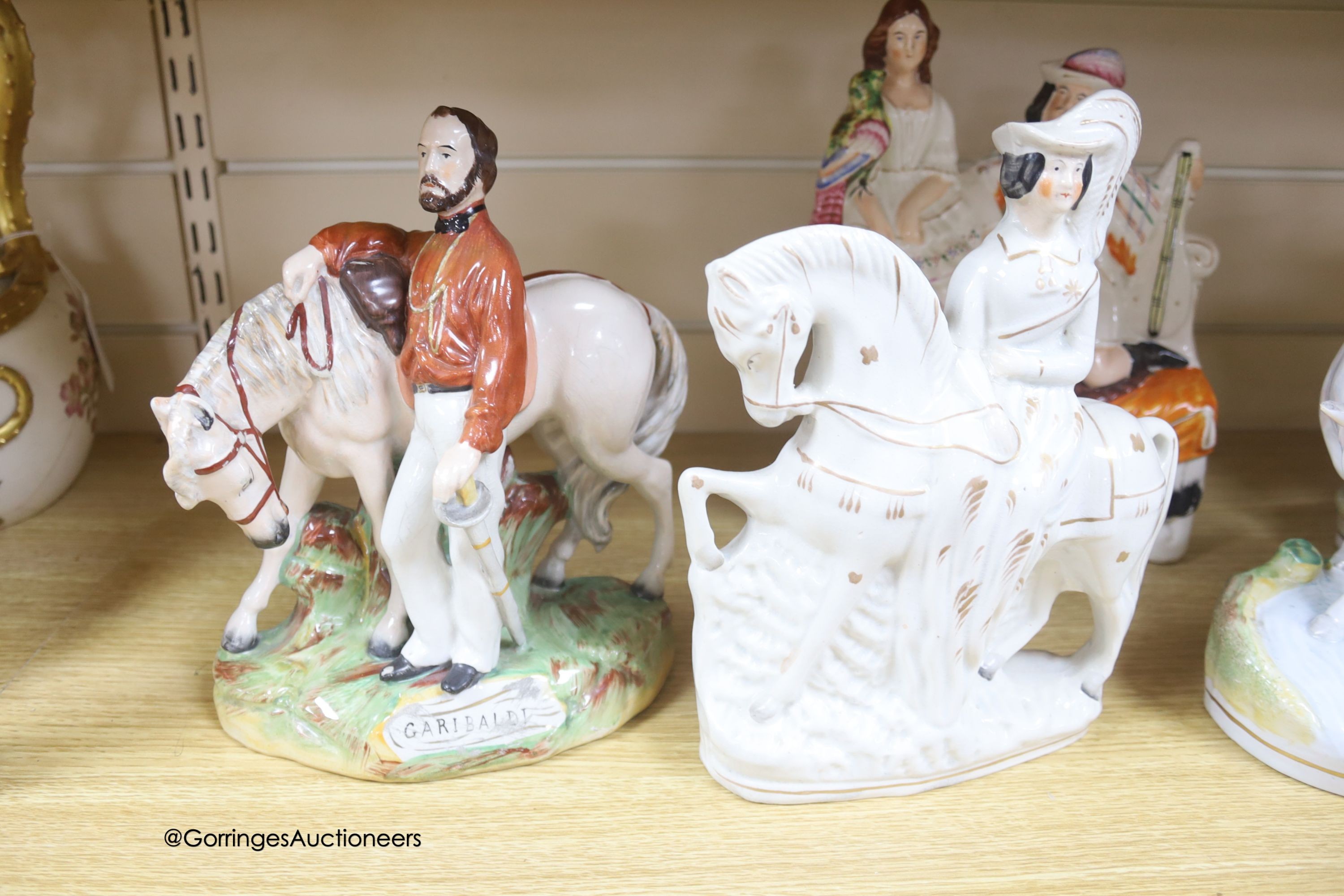 A Victorian Staffordshire group of 'Garibaldi', a similar pair of a cowherd and milkmaid and two other Staffordshire groups, tallest 27cm